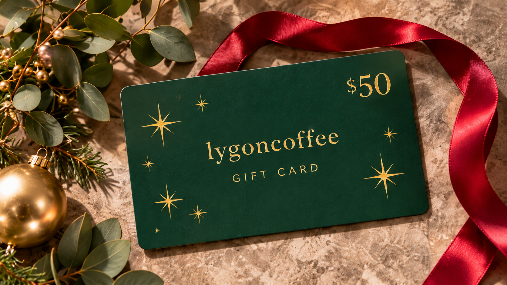 Forest green LygonCoffee $50 gift card with a red ribbon