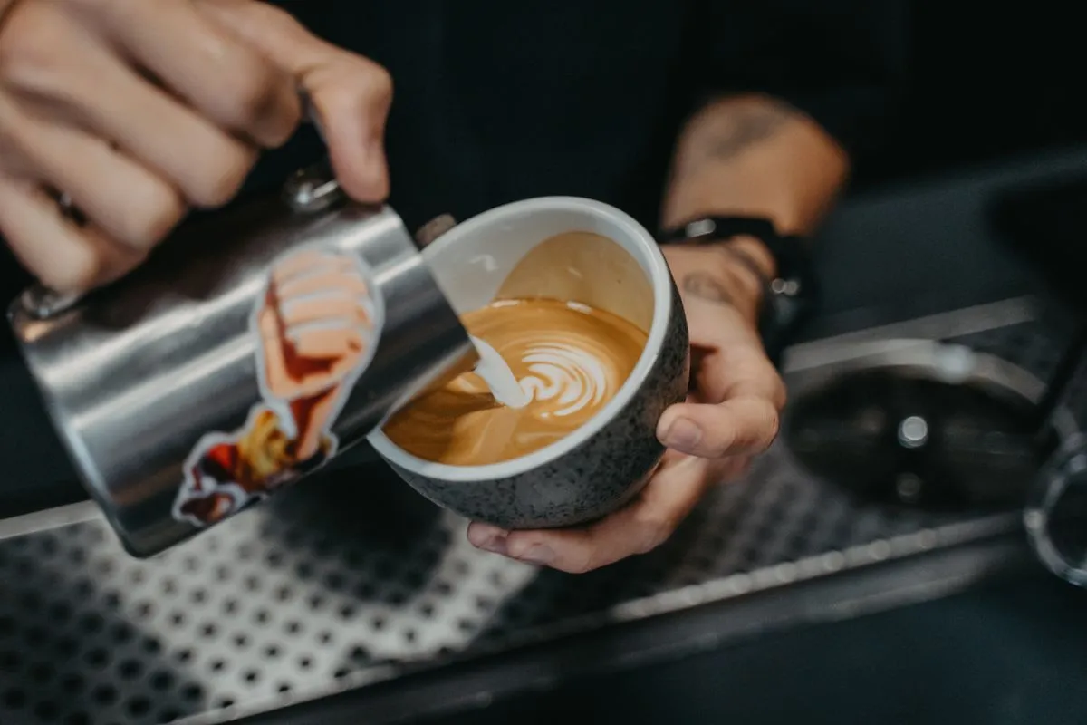 barista pouring coffee